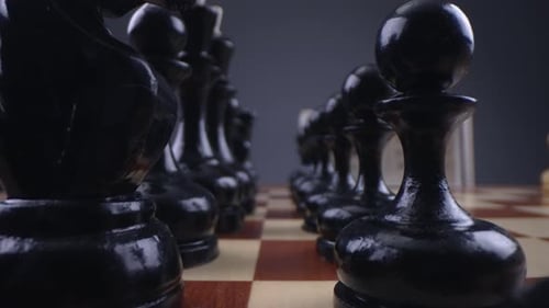 Black Chess Pieces on Board with Clock