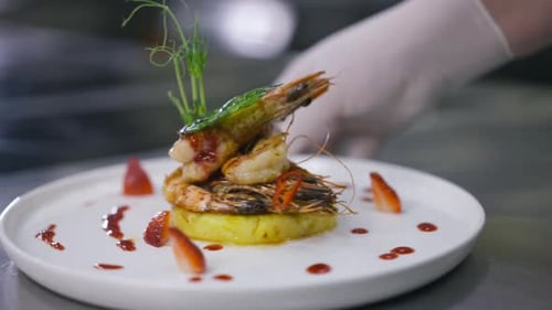 Plated Shrimp Dish Prepared by Chef in Gloves