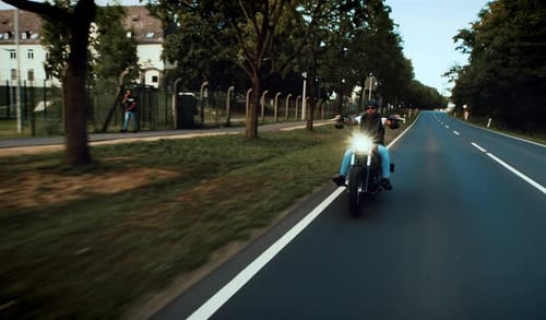 Man Rides Motorcycle on Open Road