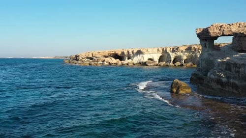 Sea caves in the stony shore of Mediterranean island