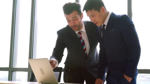 Two Business People Talk Project Strategy at Office