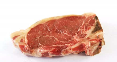 Raw steak on white background