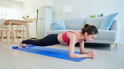Young Woman Does Plank Exercise at Home