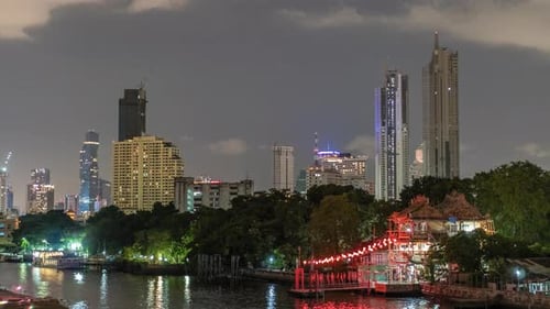 Timelapse Skyscrapers in Nightfall Downtown and River at Foreground
