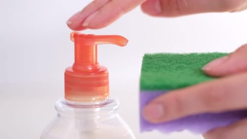 Soap Dispenser Pumping Soap onto a Sponge