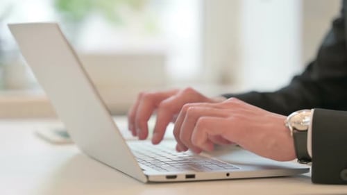 Close Up of Hands of Middle Aged Businessman Typing on Laptop