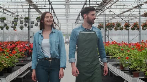 Florists Walk Through Greenhouse Filled with Flowers