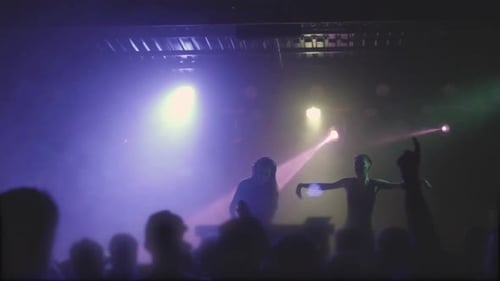 Two Beautiful Young Women DJ Play the Music on the Mixing Console in the Nightclub