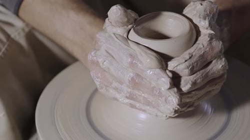 Hands Shaping Clay on Pottery Wheel, Close Up