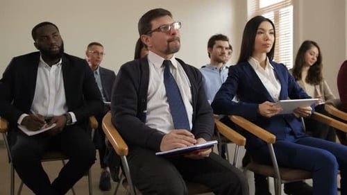 Adults Attending Business Conference and Presentation