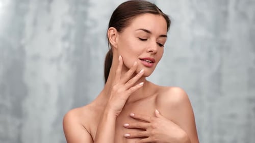 Attractive Woman Posing Indoors Touching Her Face