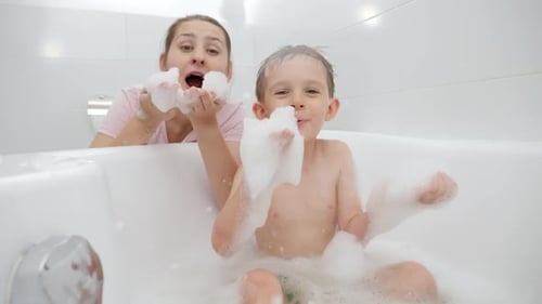 Mother and Child Laughing in a Bubble Bath