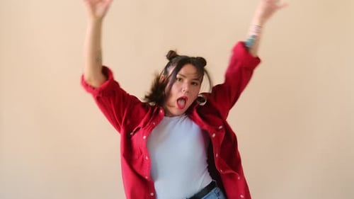 Stylish Young Woman Energetically Dancing Indoors