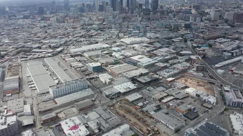 AERIAL: Warehouse District in Los Angeles Slow Tilt Up Revealing Downtown LA Skyline