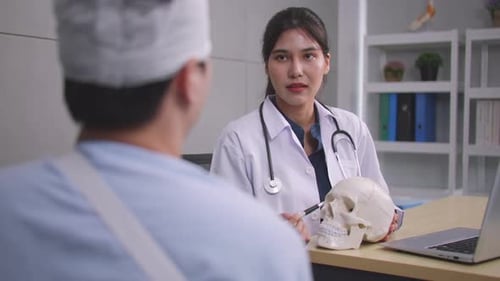 Doctor Explains Head Injury Using Skull Model