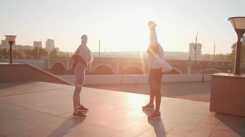Couple Stretching Together During Sunrise Workout