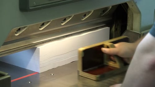 Industrial Paper Cutter in Action at Print Shop
