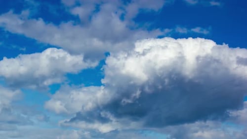 Clouds Moving Slowly Across Bright Blue Sky