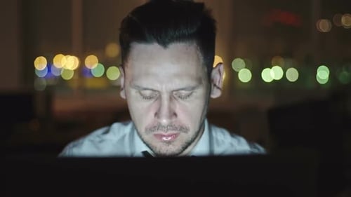 Adult Man Eating Noodles At Office Late At Night