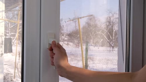 Hand Opens a White Plastic Window By the Handle Closeup