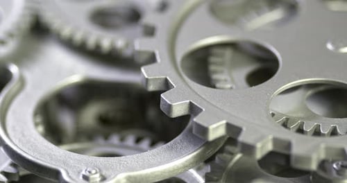 Interlocking Metal Gears Turning in Close-up