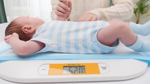 Baby on Scale During Well-Child Checkup