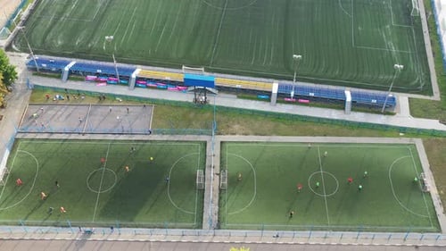 Top View of a Sports Football Field with Players Playing Football
