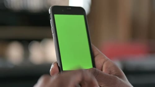 African Man Using Smartphone with Chroma Key Screen