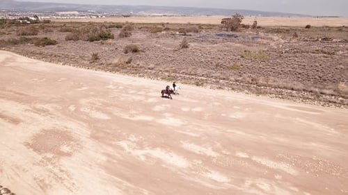 People Riding Horses Down Dirt Road