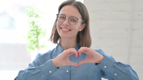 Woman Makes Heart Shape with Hands, Smiling
