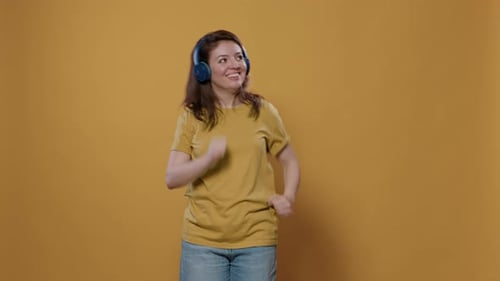 Woman with Headphones Happily Dancing to Music