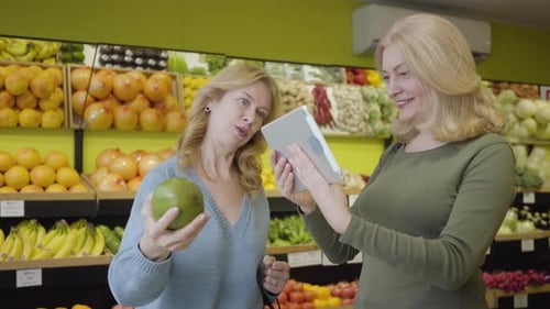 Adults Shopping for Fruits and Vegetables with Tablet