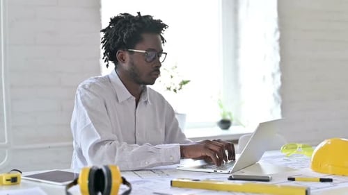 Architect Typing on Laptop, Giving Thumbs Up