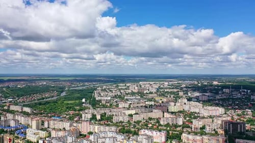 Beautiful cityscape. Panorama of a city under white clouds.