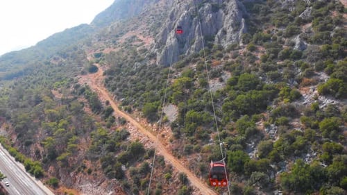 Close-up Flight Next To the Uphill Funicular with the Coast in the Background