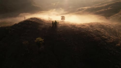 4K Flying through the clouds above mountain tops. Tropical forest with smoke and fog.
