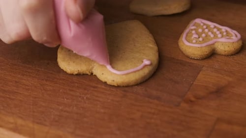 Decorating Heart-Shaped Cookies with Pink Icing