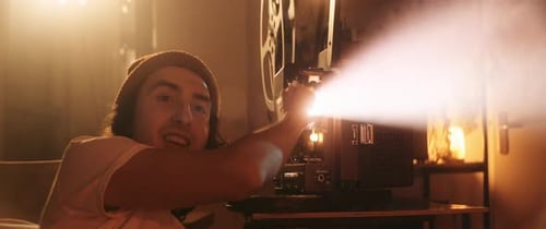 Enthusiastic man operating a vintage film projector