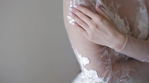 Elegant Woman in Wedding Dress Holds Arm