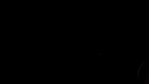 Legs Kicking a Soccer Ball at Night