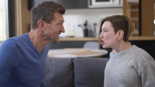 Side View Furious Aggressive Couple Screaming Gesturing Arguing at Home Indoors