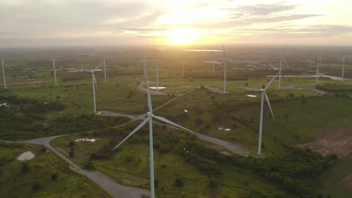 Aerial view of wind turbines or windmills farm field in industry factory. Power,