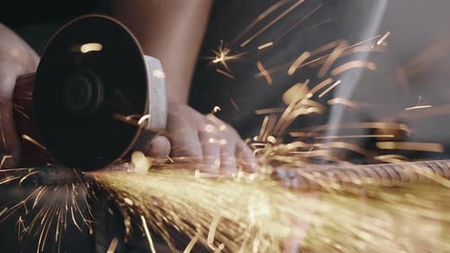 Tradesman Grinding Metal with Sparks Flying