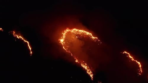 Aerial View. Night Fire. On the Field Burning Dry Grass. .