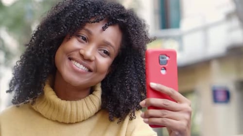 Young Woman Video Chatting on Phone Outdoors