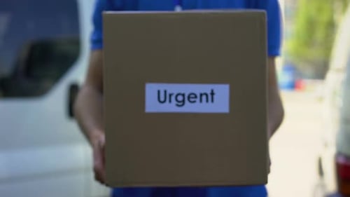 Urgent Delivery Courier in Uniform Holding Cardboard Box, International Shipping