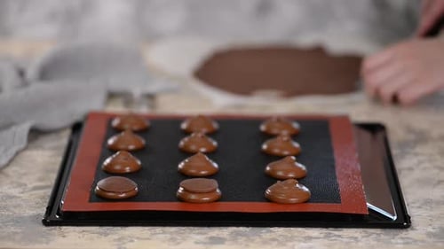 Woman Hands Assembling Chocolate Cookies on Baking Sheet