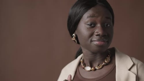 Elegant Woman Puts on Earring and Smiles