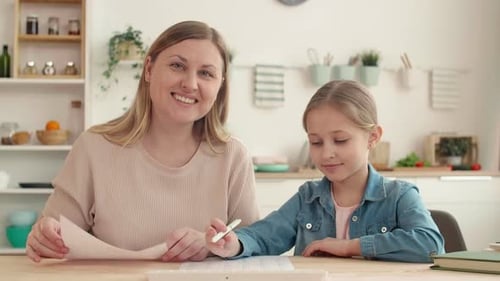 Mother and Daughter Doing Homework at Home