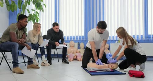 Adults Learning CPR in a First Aid Training Course